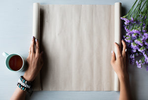 Sheet of paper on a table with hands