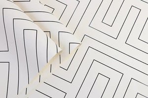 Detail of black and white geometric labyrinth patterned vinyl wallpaper