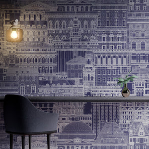 Room decorated with cityscape patterned vinyl wallpaper printed in silver on a blue background