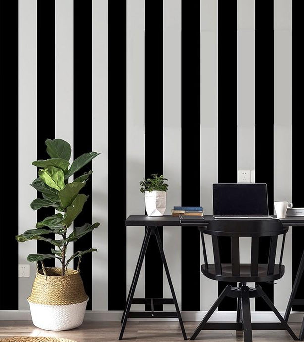 Home office decorated with black and white thick striped wallpaper