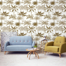 Load image into Gallery viewer, Living room wall with tropical non woven wallpaper illustrated with golden palm trees on a white background
