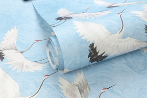 Detail of beautiful flying crane wallpaper with light blue background