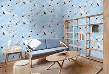 Load image into Gallery viewer, Contemporary living room decorated with flying crane patterned wallpaper with sky blue background
