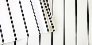 Detail of black and white pin striped wallpaper