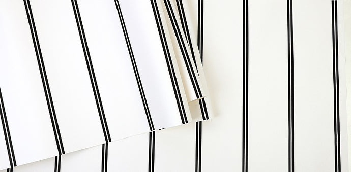 Detail of black and white pin striped wallpaper