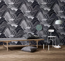Load image into Gallery viewer, Stylized rolling mountain patterned non woven wallpaper in charcoal and black displayed in a room with contemporary decor
