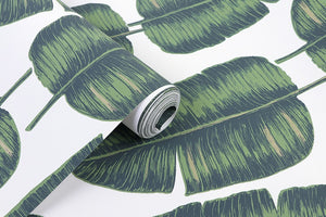 Detail of tropical green and gold banana leaf patterned non woven wallpaper