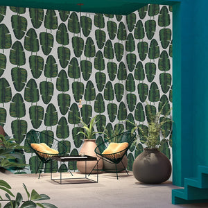 Tropical green and gold banana leaf patterned wallpaper decorating a room