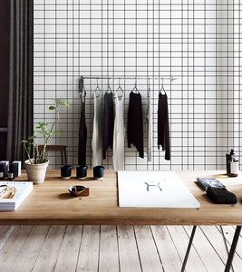 Clothing store decorated with white grid patterned vinyl wallpaper